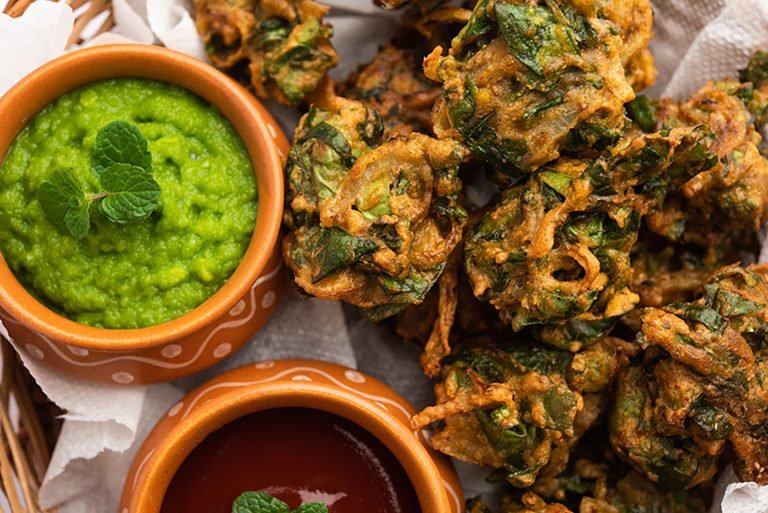 Homemade tasty Palak pakoda or pakora known as Spinach Firtters, served with ketchup. Favourite Tea-time snack from India